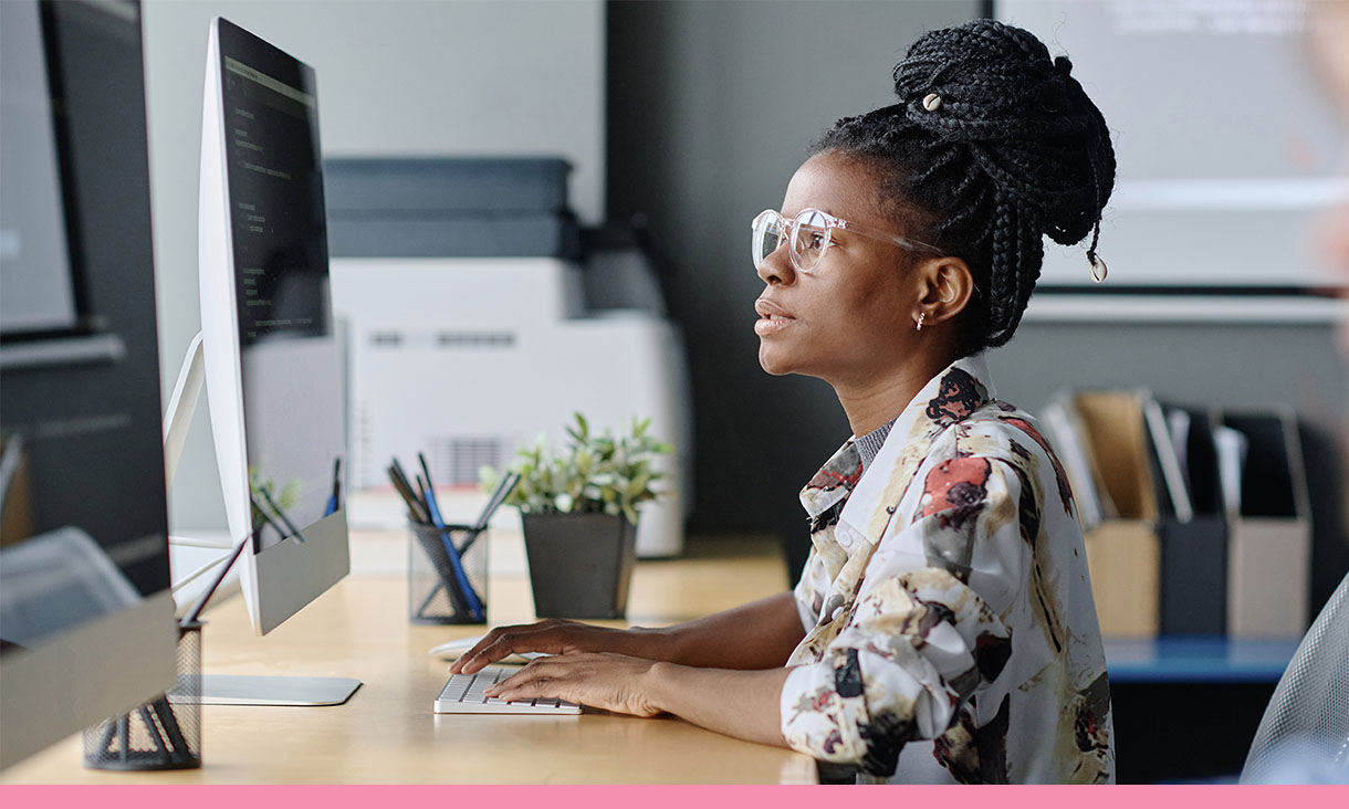 A woman works at her desk.