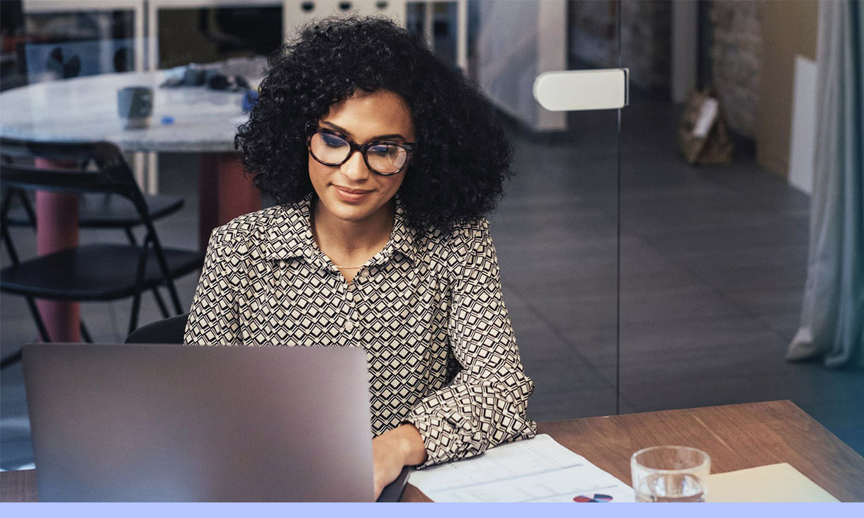 A woman works at her desk.