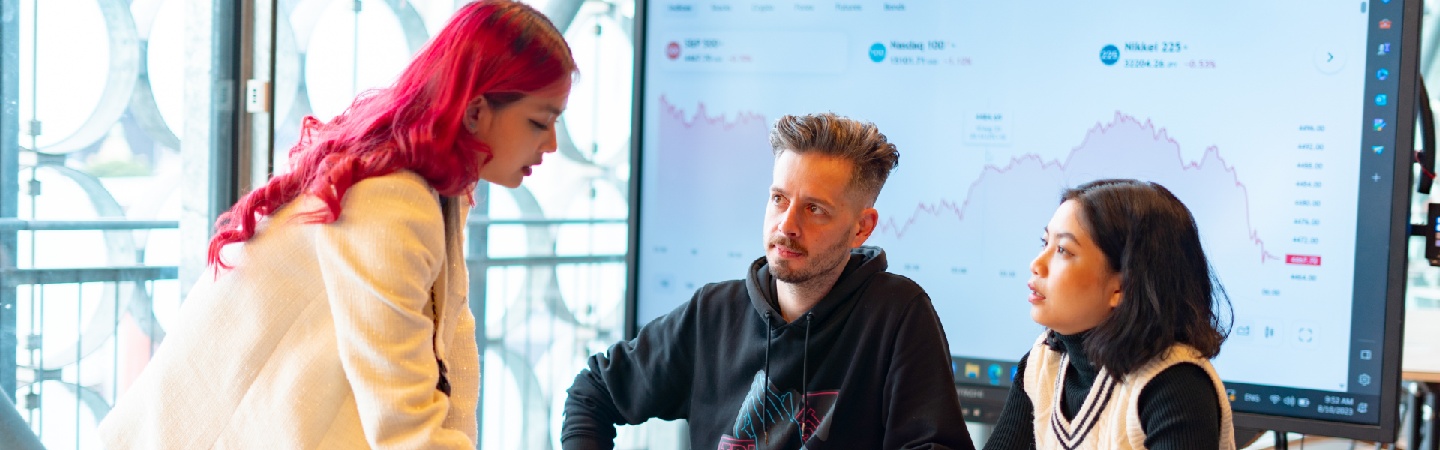 Close-up shot of hands pressing down pages of a RMIT brochure