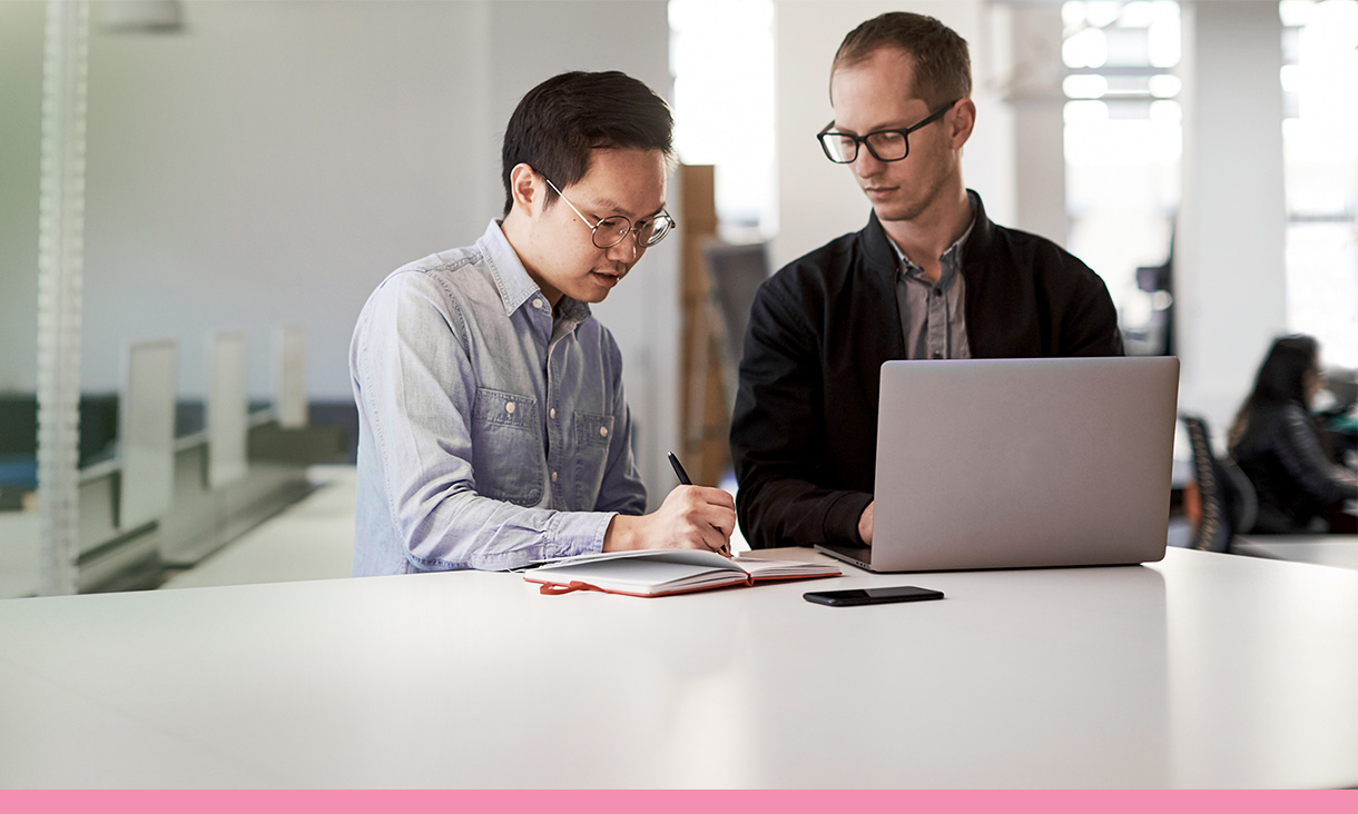 Two coworkers work together.