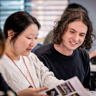 An international student with a teaching smiling in an Art class