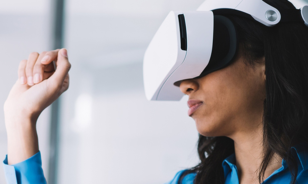A women in a blue shirt with a VR headset on. 