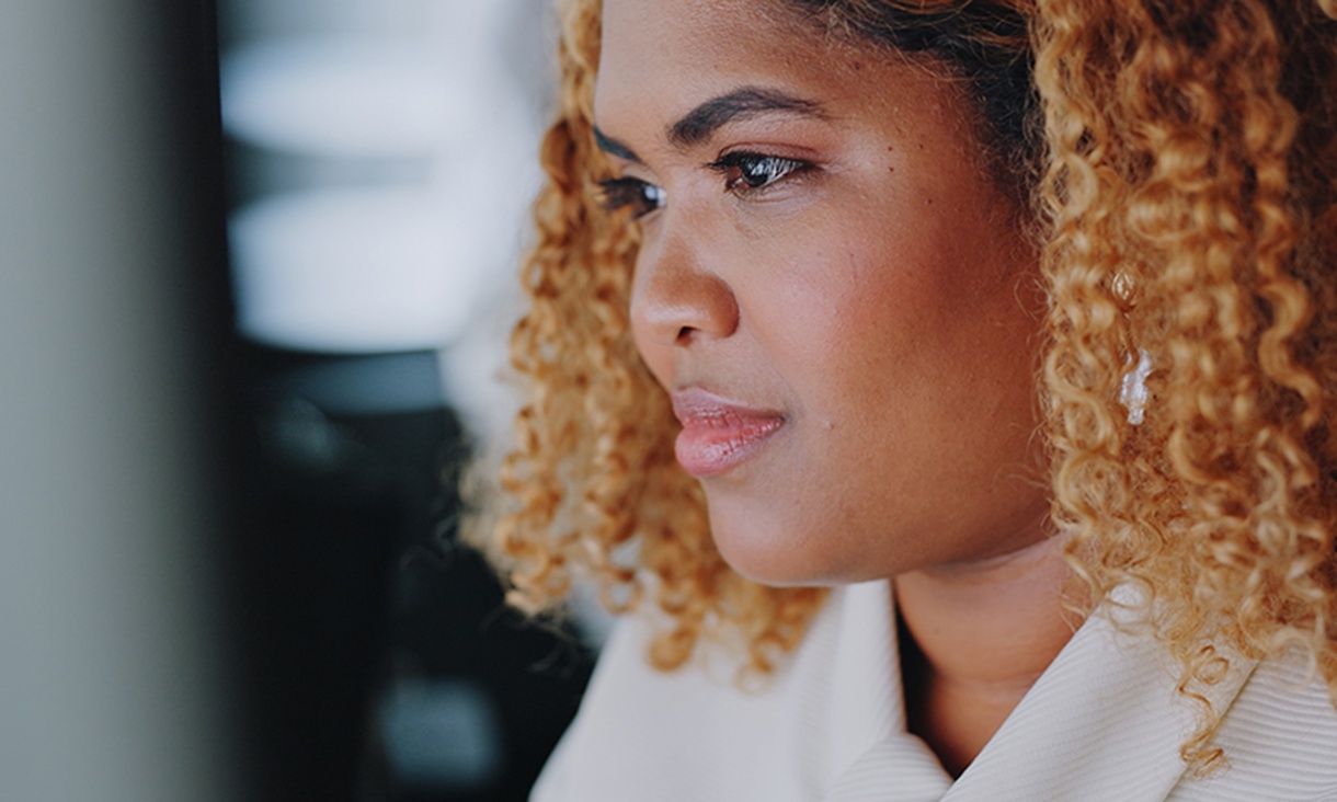 A woman looks at her computer.