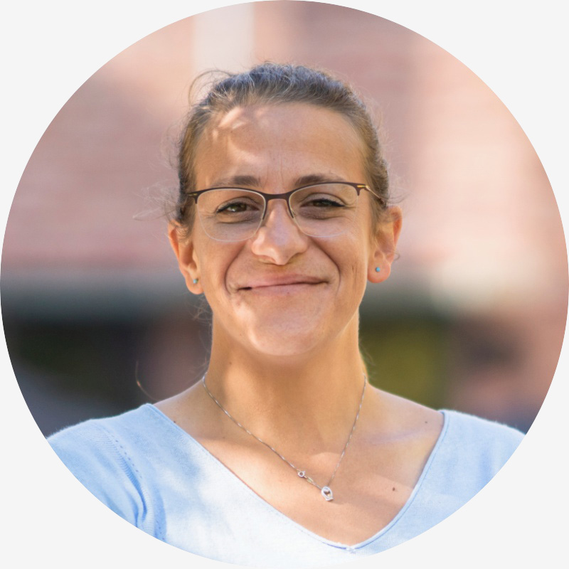 Portrait of Steph Worladge, a woman with light skin, dark blonde, wearing a light blue shirt and rimless glasses.