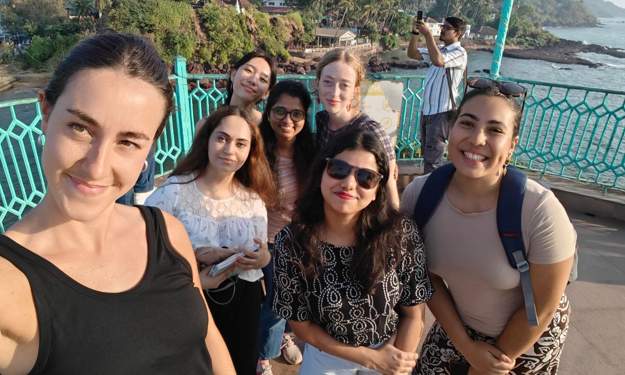 Group of students taking a selfie on a pier overlooking water